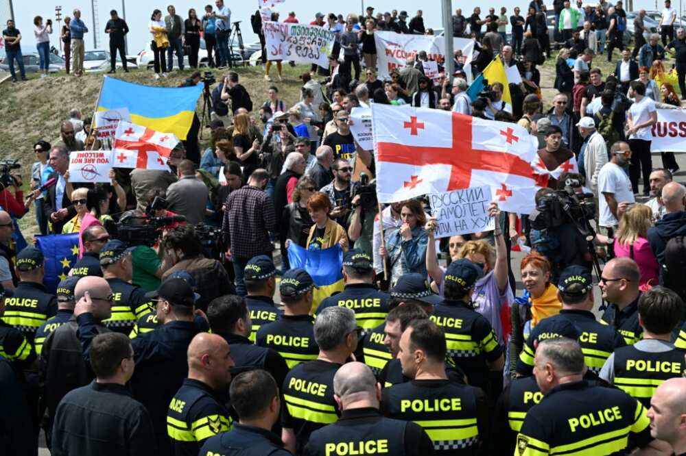 Georgian demonstrators protest against the resumption of air links with Russia outside Tbilisi Airport