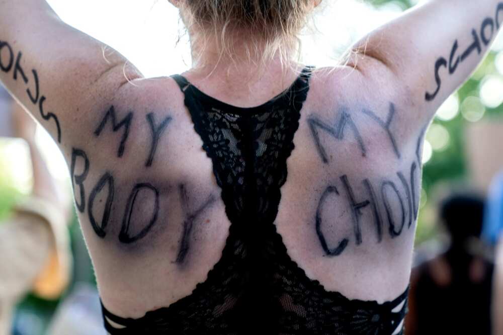 An abortion rights demonstrator marching to the houses of US Supreme Court justices Brett Kavanaugh and John Roberts in Chevy Chase, Maryland An abortion rights demonstrator marching to the houses of US Supreme Court justices Brett Kavanaugh and John Roberts in Chevy Chase, Maryland