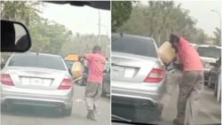 Things still dey shock una for Nigeria? Reactions as Abuja man pours fuel into a moving car in stunning video