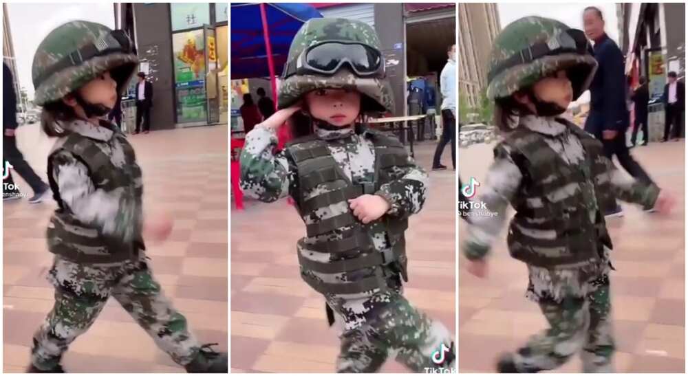 Kid salutes like a smart soldier.