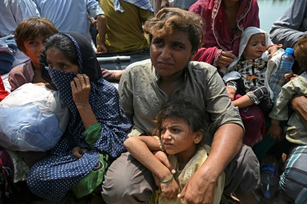Basti Ahmad Din residents sit in a boat after being rescued from their flooded houses by Pakistani naval personnel Basti Ahmad Din residents sit in a boat after being rescued from their flooded houses by Pakistani naval personnel