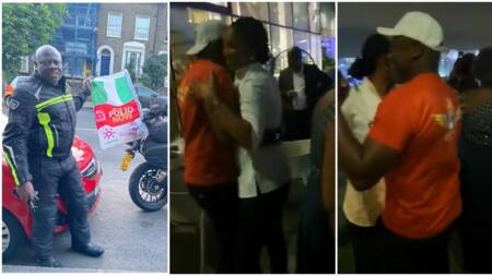 Pretty young lady takes the hand of London to Lagos biker, drags him to dancing floor, they dance in video