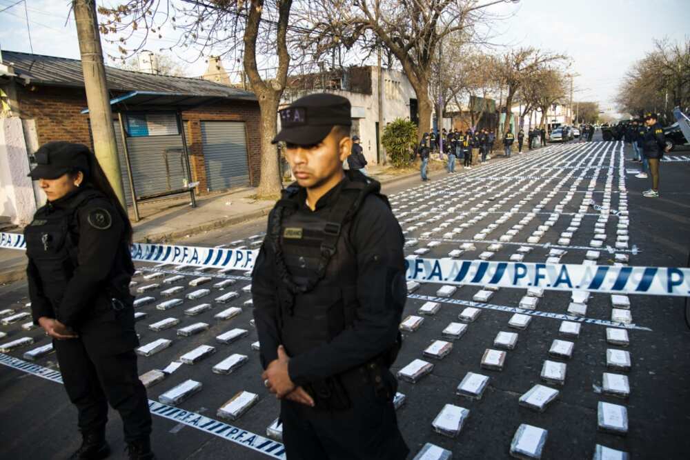 Argentine federal police officers guard cocaine packets seized in the city of Rosario