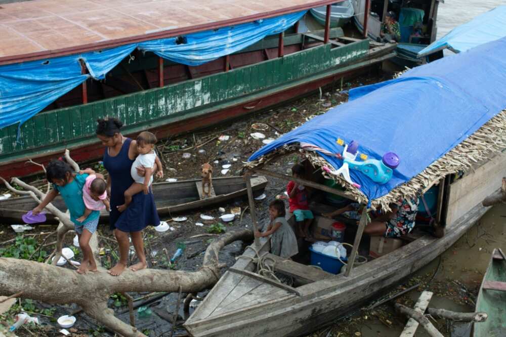 Experts say poverty is fueling crime in Brazil's Javari Valley -- here, an Indigenous family is termporarily living on this boat