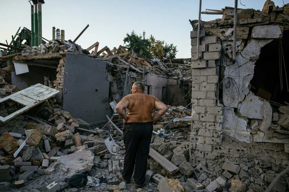 Oleksandr Shulga looks at his destroyed house following a missile strike in Mykolaiv on August 29, 2022