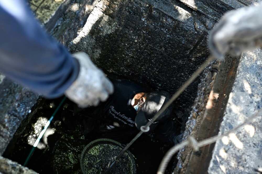 After hauling up the concrete slabs covering the drains, the inmates drop down and scrabble out the grime, filling large iron tubs with stinking slop