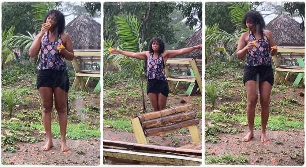 Photos of a beautiful lady playing under the rain in her village.