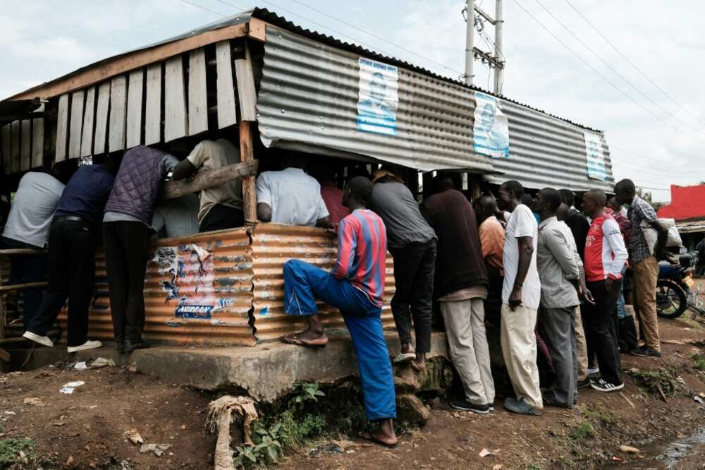 Supporters of Raila Odinga watch television  as they wait for the results of Kenya's election