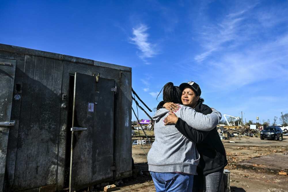 Tracy Harden (R) and Barbara Nell McReynolds-Pinkins hid, along with coworkers, inside a giant restaurant cooler during a tornado that roared through the town of Rolling Fork, Mississippi