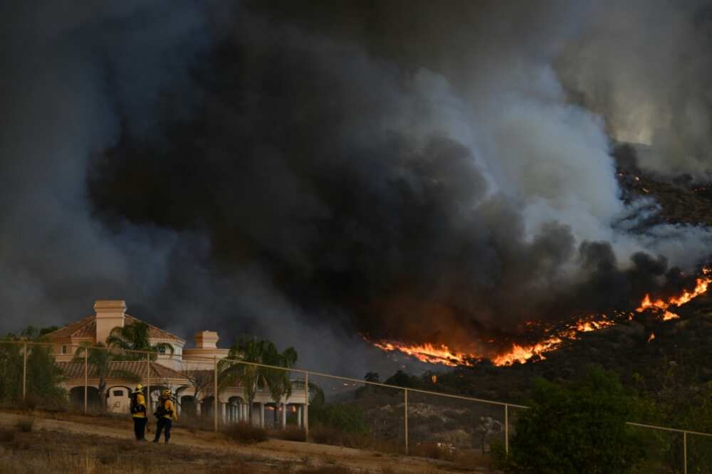 Plumes of smoke rise as wildfire approaches a home near Hemet, California in September 2022