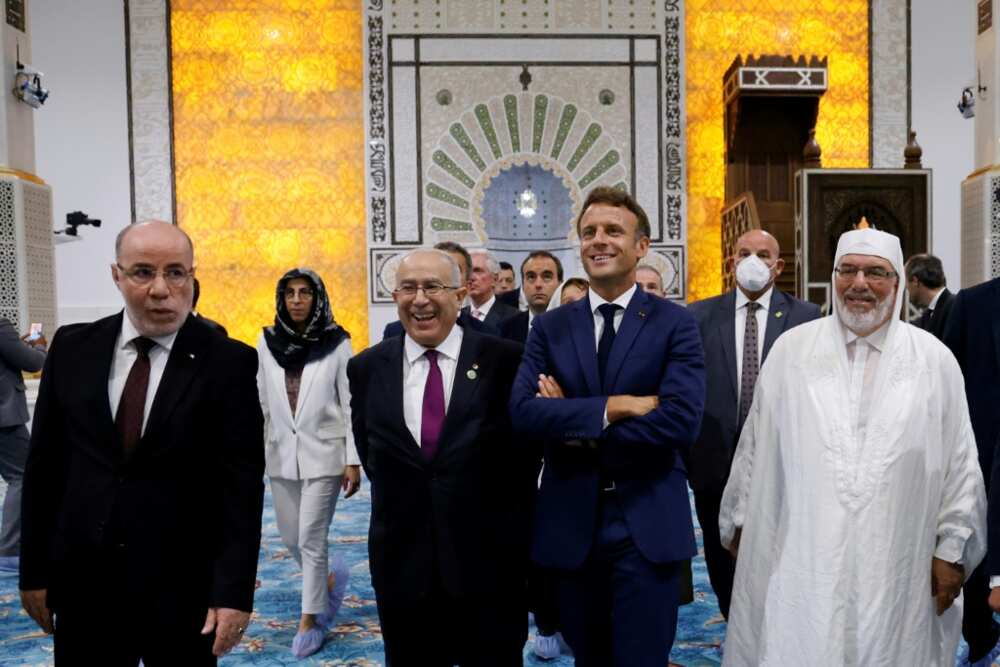 French President Emmanuel Macron (3rd R) visits the Great Mosque of Algiers, accompanied by Algerian Foreign Affairs Minister Ramtane Lamamra (2nd L) and the mosque's imam, Mohamed Mamoun El-Kacimi El-Hassani (R)