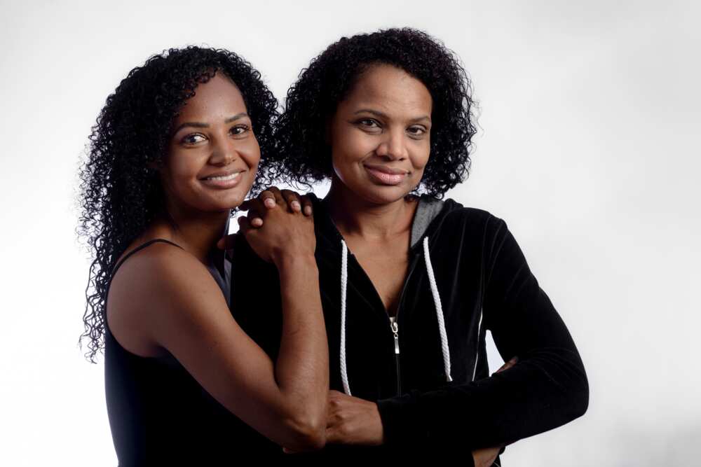 Sisters together in photo studio looking at camera