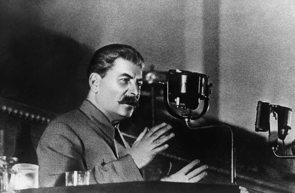A black and white photo of Joseph Stalin making an address