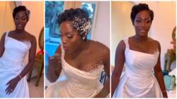 Ebony bride glows in wedding look as she sports curly pixie hairstyle with stunning dress
