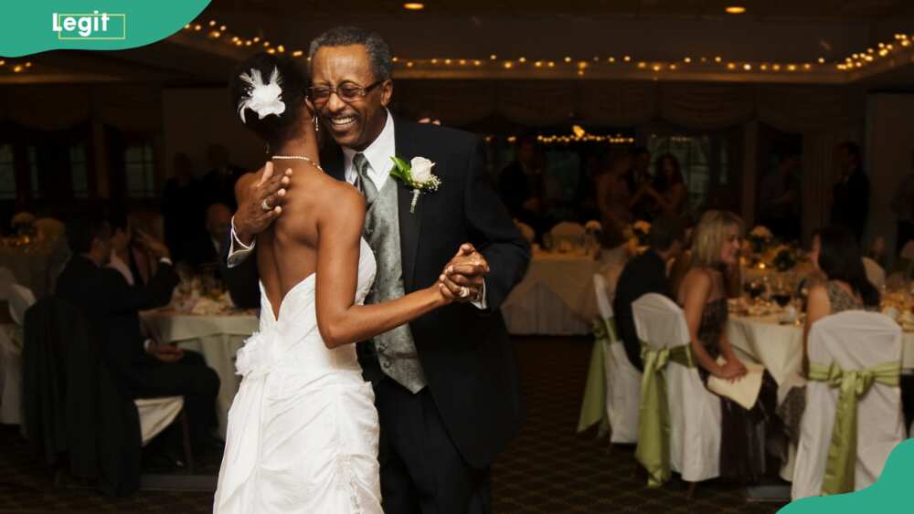 A bride and father dancing at wedding reception