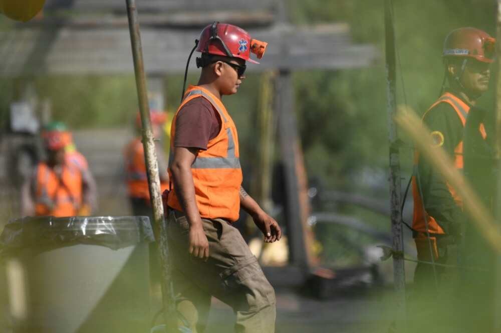 Rescuers take part in an operation to try to find 10 miners trapped in northern Mexico