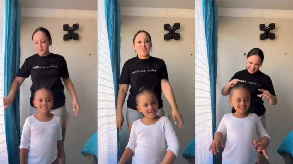 Little girl shows her mom how to do tough dance