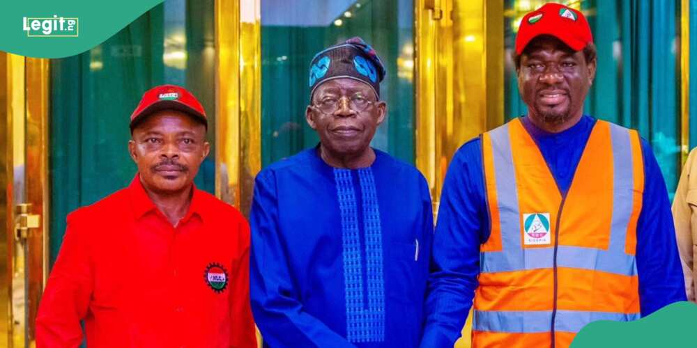 Tinubu poses with NLC leader during a meeting