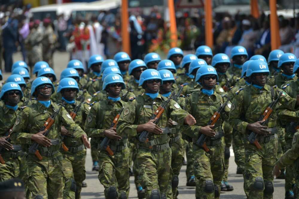 Ivory Coast troops march under the MINUSMA flag in Abidjan