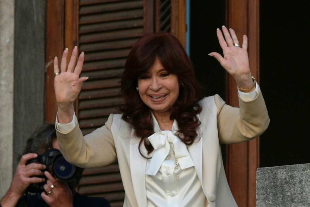 Argentine Vice-President Cristina Kirchner waves to supporters from the senate balcony a day after prosecutors recommend she be jailed for 12 years for graft