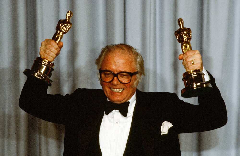 Richard Samuel Attenborough poses with trophies after winning awards