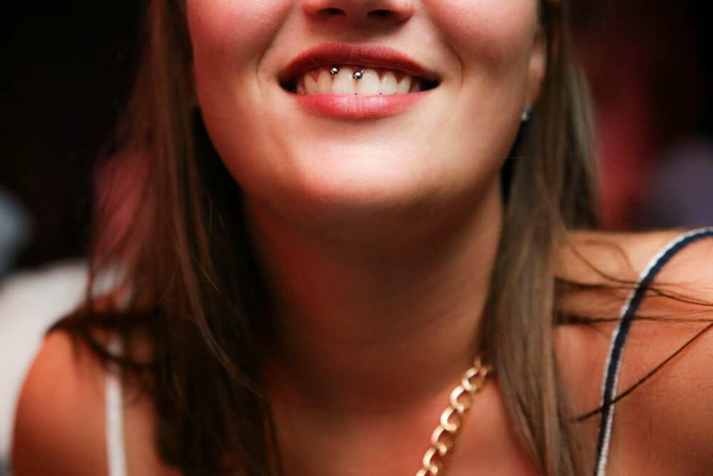 A woman with smiley piercing