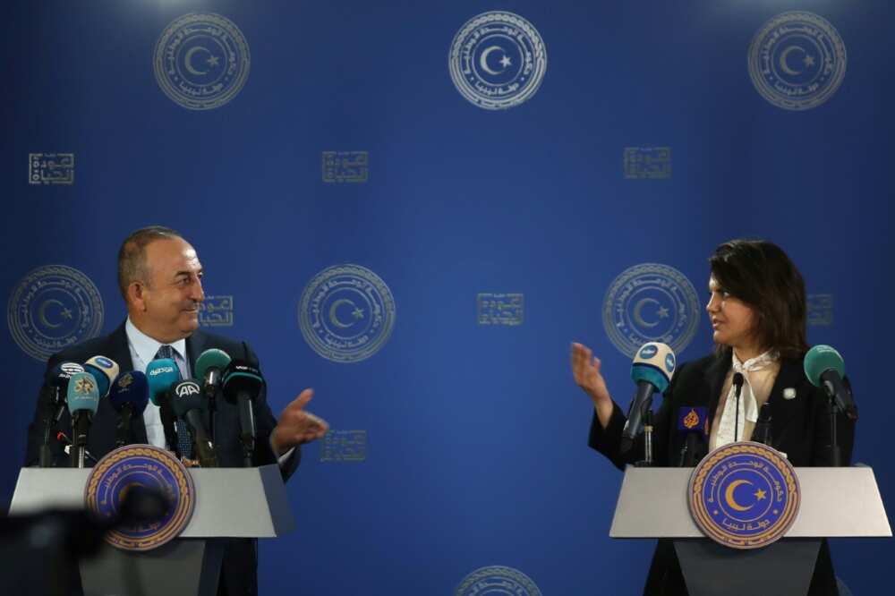 Libyan Foreign Minister Najla al-Mangoush and Turkish Foreign Minister Mevlut Cavusoglu speak to reporters after s signing a maritime gas deal