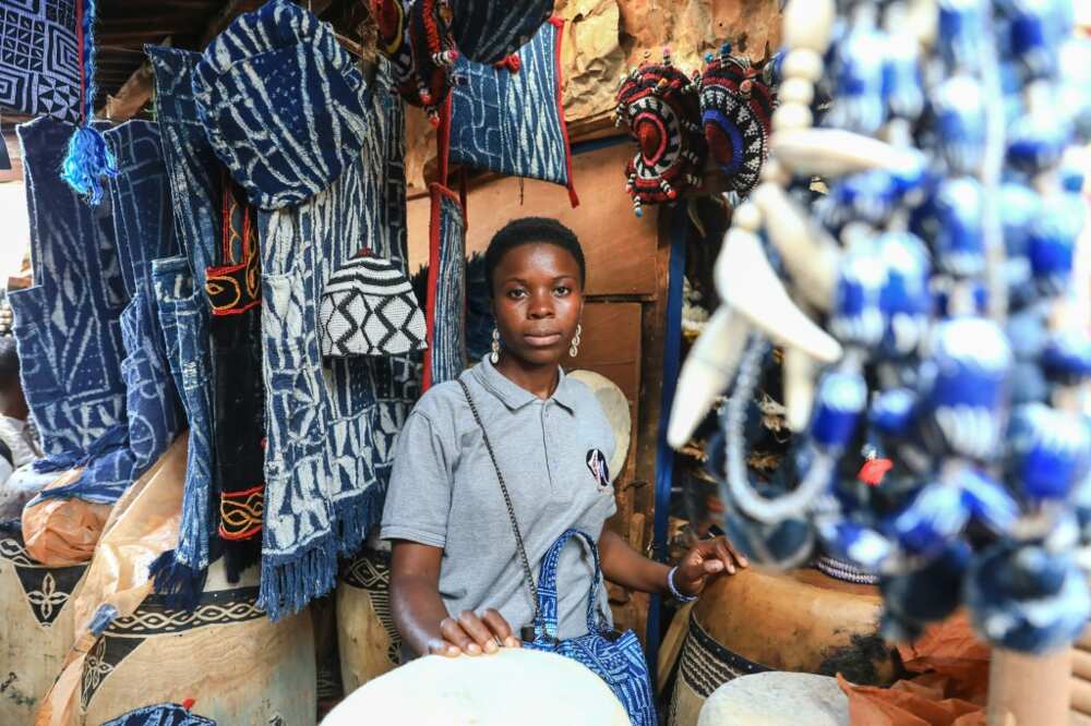 Young designer Yougo Teguia Doriane in a shop selling ndop clothes and accessories in Bafoussam, Cameroon