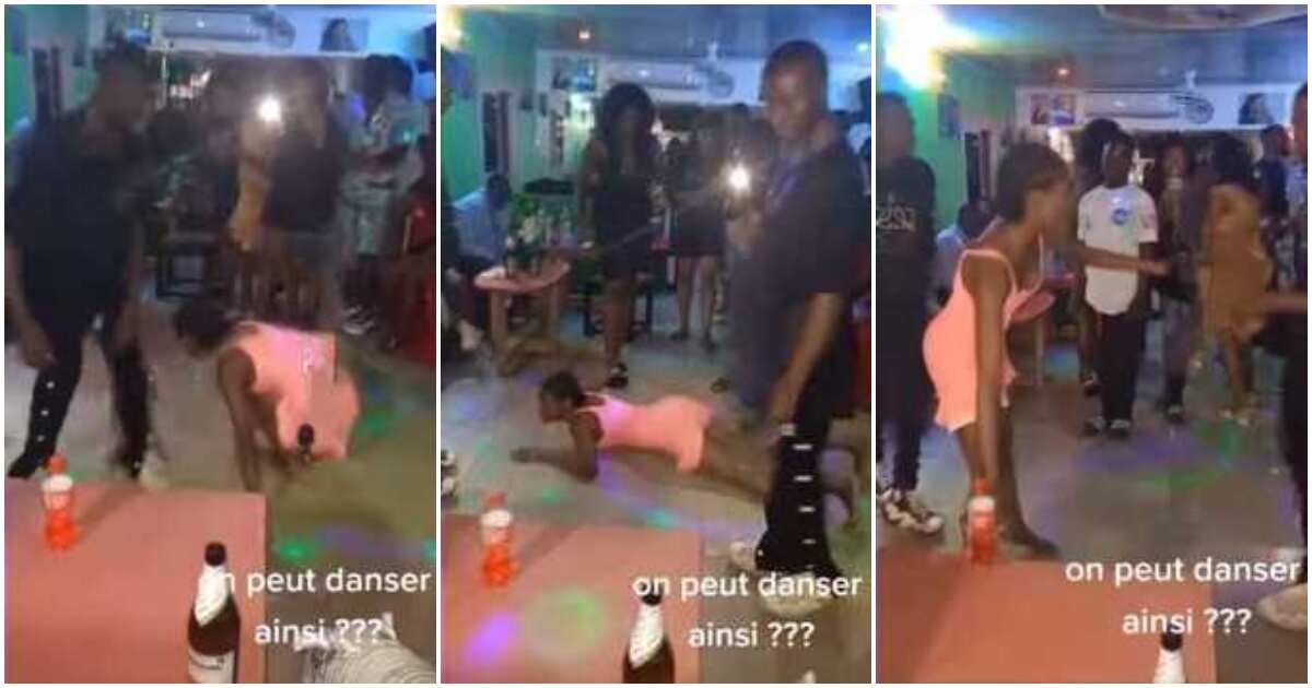 Nigerian lady in dress dances on her belly like snake at club, throws legs up in video, people stood up in awe