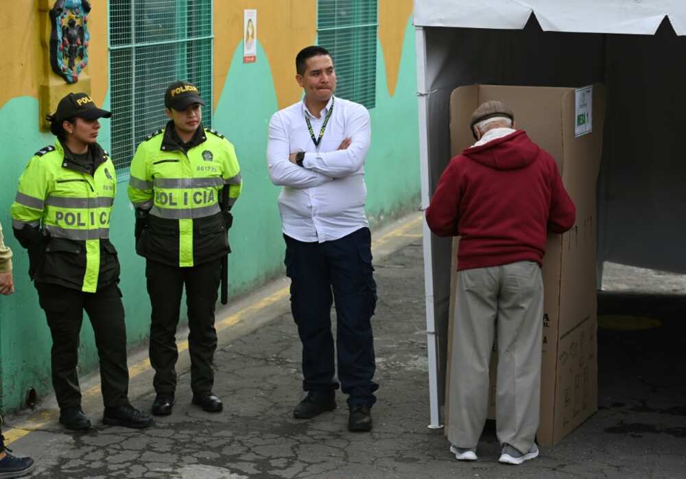 A man votes during the Colombian presidential runoff election, in Bogota on June 19, 2022, with voters filled with uncertainty over deciding between ex-guerrilla Gustavo Petro and millionaire businessman Rodolfo Hernandez