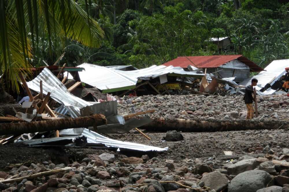 About 60 houses were buried, while a few others made of lighter materials were swept down towards the road below, said Lieutenant-Colonel Dennis Almorato