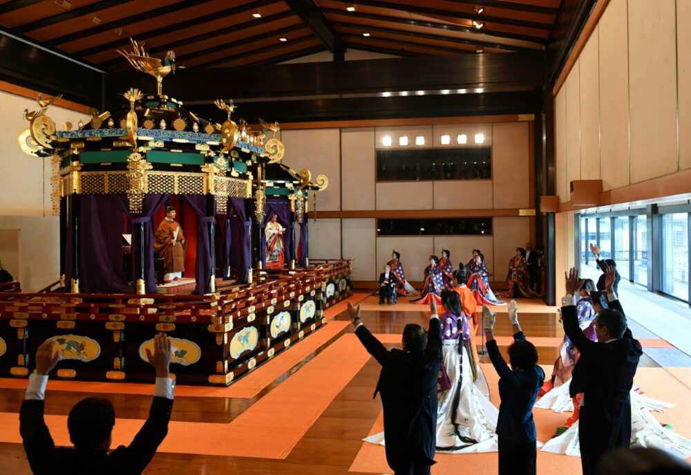 Japan's Abe assisted in the tradition-bound official ascension to the throne of the new emperor, leading a cheer of Banzai!