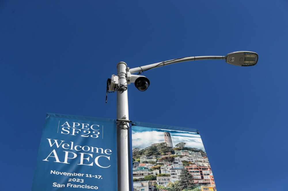 A security camera is seen by a sign announcing the Asia-Pacific Economic Cooperation (APEC) summit as security preparations get under way in San Francisco, California