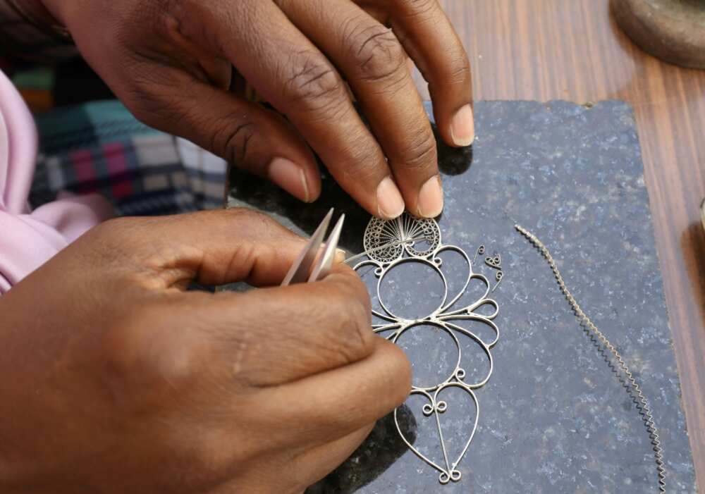 A Libyan woman crafts a piece of traditional filigree jewellery