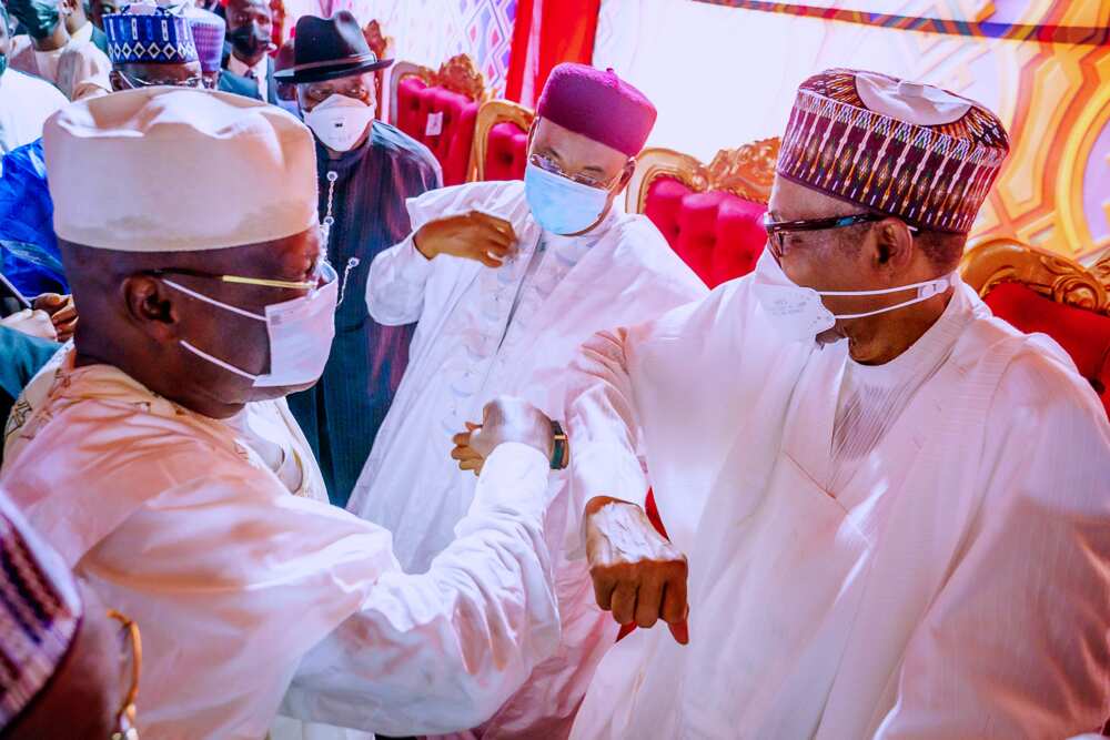 Atiku and Buhari greeting with their elbows