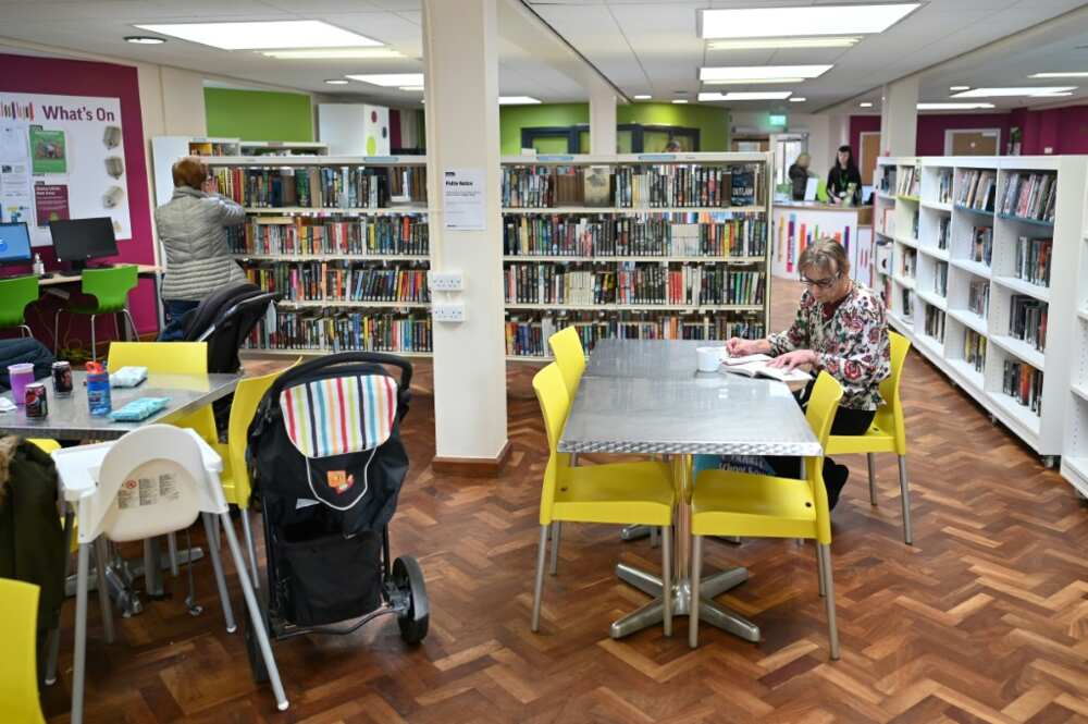 Marina Flynn, sitting with a book and a coffee, says the library is 'a great warm space to come to' Marina Flynn, sitting with a book and a coffee, says the library is 'a great warm space to come to'