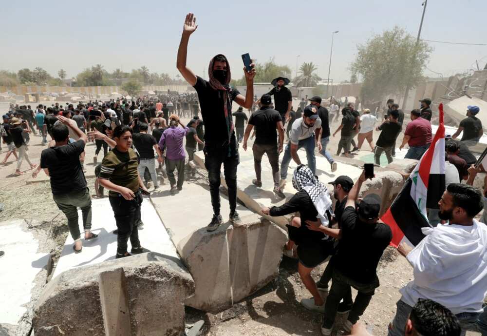 Supporters of the Iraqi cleric Moqtada Sadr celebrate after bringing down concrete barriers leading to the capital Baghdad's high-security Green Zone and the country's parliament Supporters of the Iraqi cleric Moqtada Sadr celebrate after bringing down concrete barriers leading to the capital Baghdad's high-security Green Zone and the country's parliament