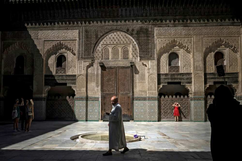 Visitors tour the Bou Inania madrassa, a theological school built between 1350 and 1355 AD, in the ancient Moroccan city of Fez