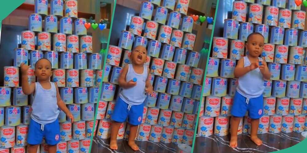 Little boy shows off empty cans of milk