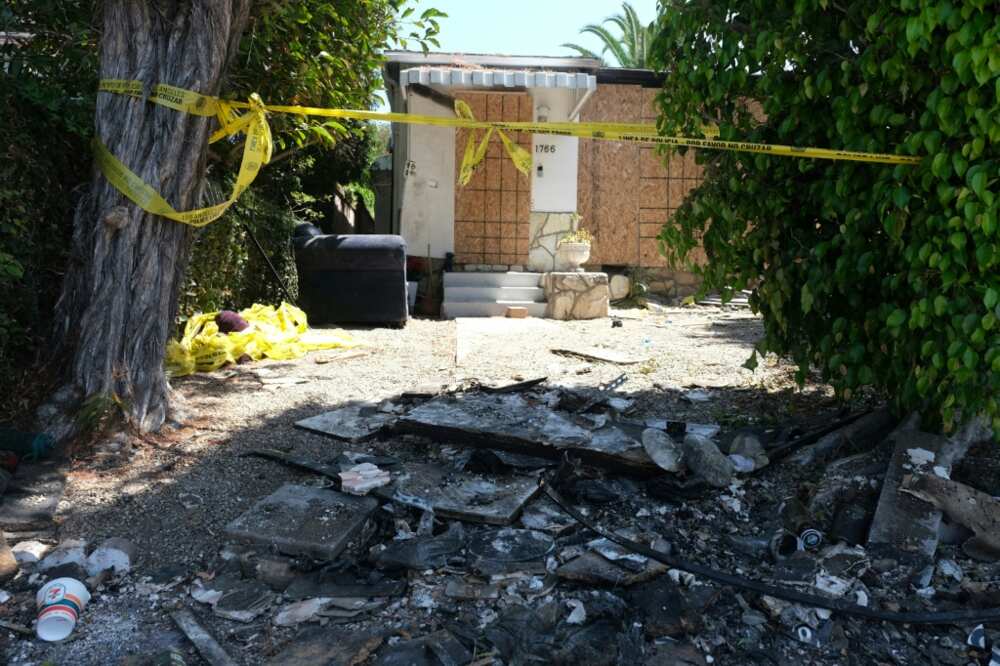 Charred debris and caution tape are seen at the home where US actress Anne Heche crashed her car last week