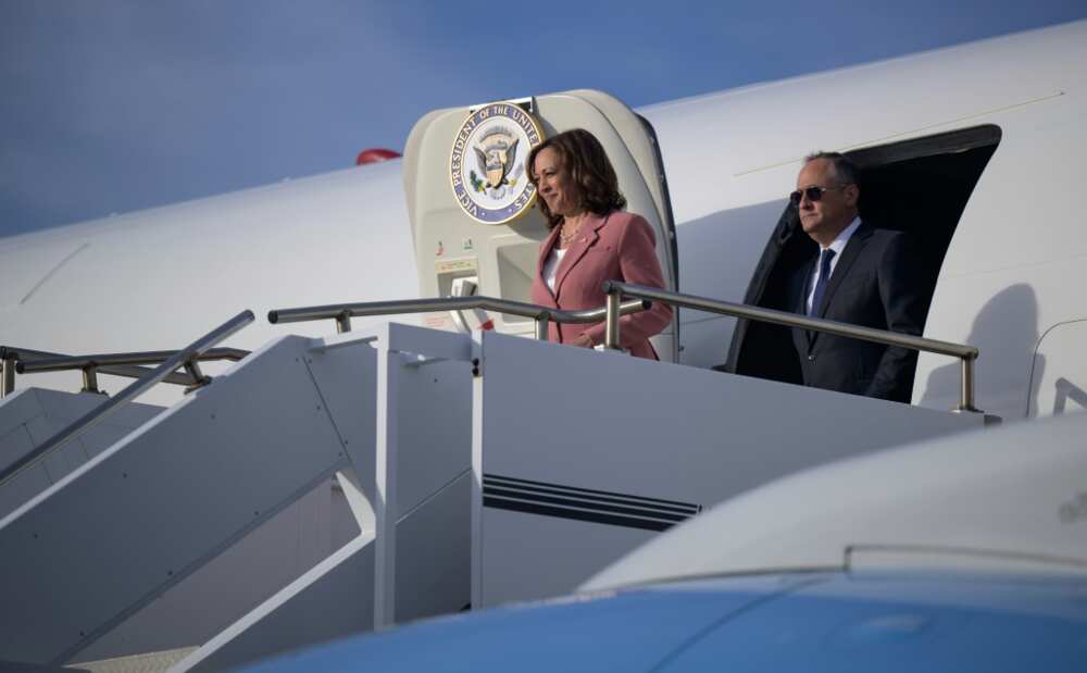 In this handout image courtesy of NASA, US Vice President Kamala Harris and Second Gentleman Doug Emhoff exit their aircraft after landing at the ennedy Space Center in Cape Canaveral, Florida