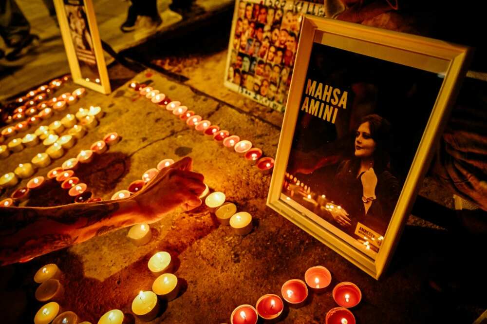 Iranians in Greece light candles forming the name "Mahsa" during a demonstration on October 30, 2022 to commemorate 40 days after the death of Mahsa Amini, who was arrested by the notorious morality police