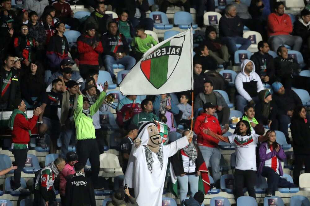Francisco Muñoz (C), a 48-year-broken-down janitor, cheers for his crew Palestino wearing an Arab sheikh costume all over the Copa Sudamericana match in opposition to Estudiantes de Merida in Rancagua, Chile, on April 18, 2023 Francisco Muñoz (C), a 48-year-broken-down janitor, cheers for his crew Palestino wearing an Arab sheikh costume all over the Copa Sudamericana match in opposition to Estudiantes de Merida in Rancagua, Chile, on April 18, 2023