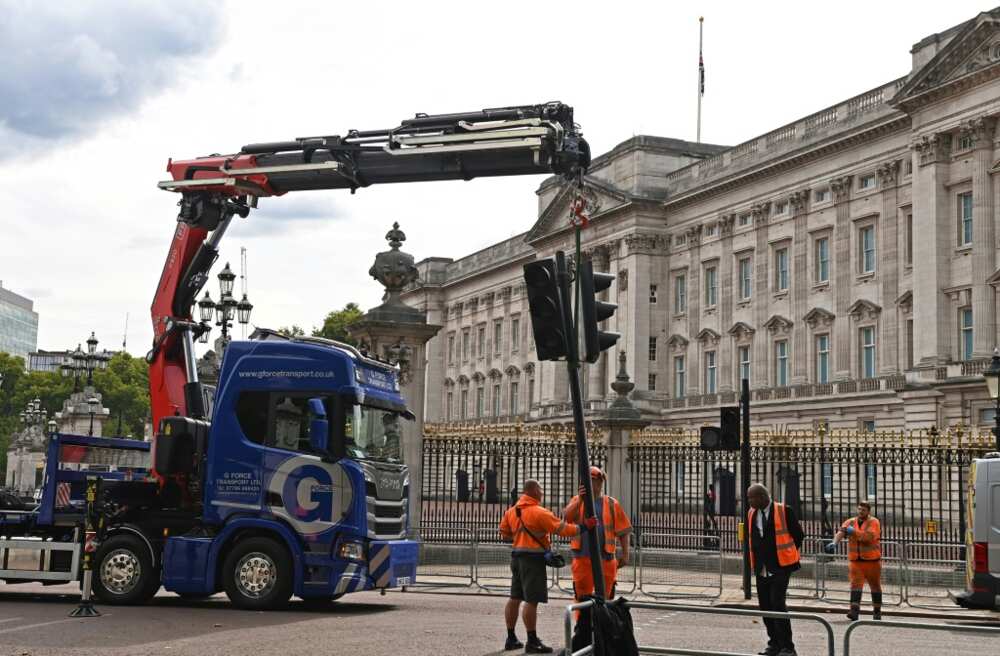Workers re-installed traffic lights, removed for the funeral of Queen Elizabeth II, outside Buckingham Palace