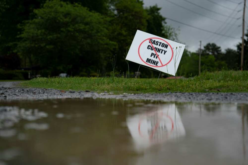Signs indicating opposition are seen outside homes near a proposed lithium mine in North Carolina