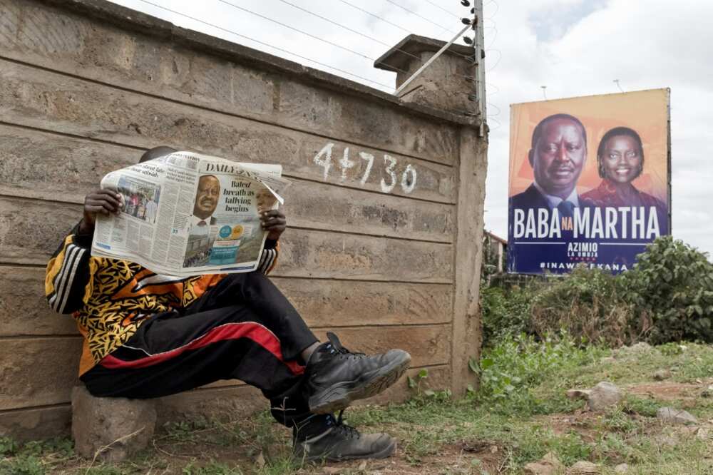 The race is currently too close to call between presidential frontrunners William Ruto and Raila Odinga (left on the billboard)