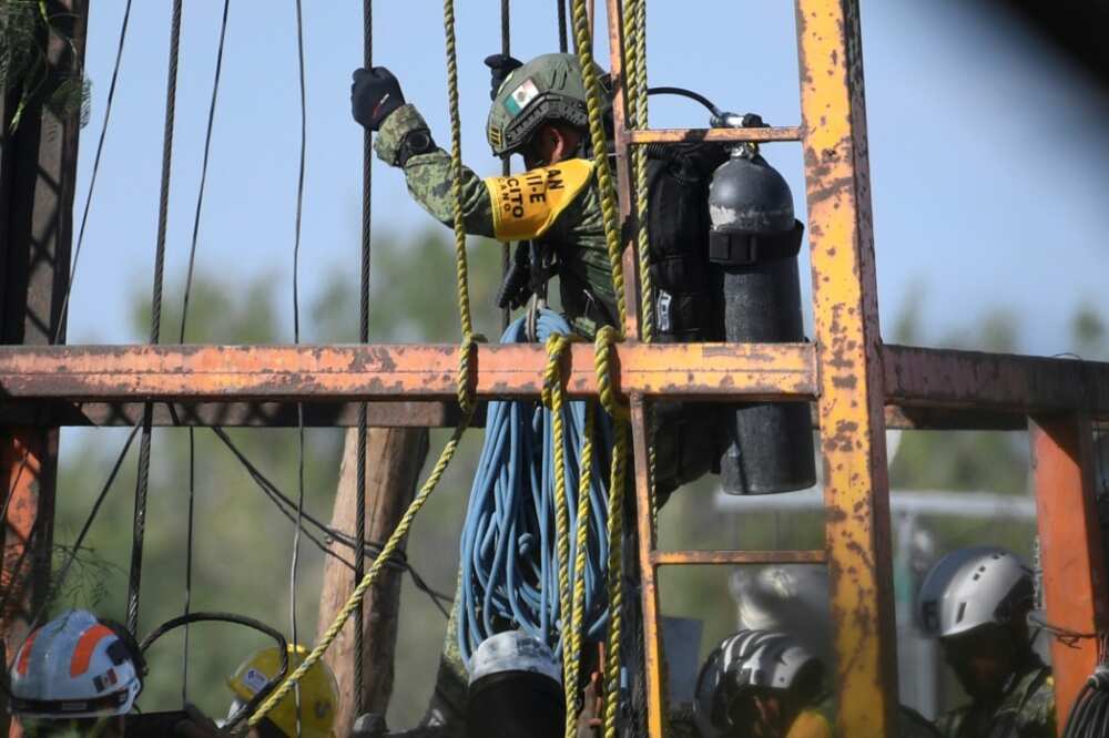 A soldier is lowered into a flooded mine in Mexico in a bid to reach 10 miners trapped inside A soldier is lowered into a flooded mine in Mexico in a bid to reach 10 miners trapped inside