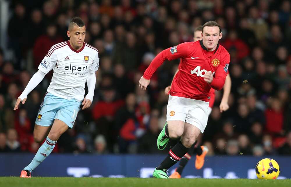 Ravel Morrison and Wayne Rooney in action.