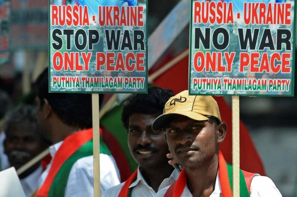 Members of the Puthiya Tamilagam party hold placards for a peaceful end to Russia's invasion of Ukraine at a March 2022 demonstration in Chennai