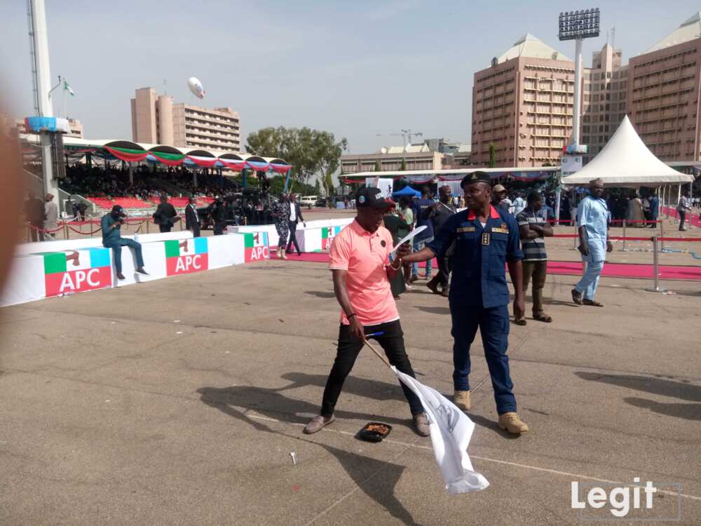 A Pro-Tinubu Supporter Waving a Flag of Bola Tinubu’s Image at the Eagle Square, Abuja.